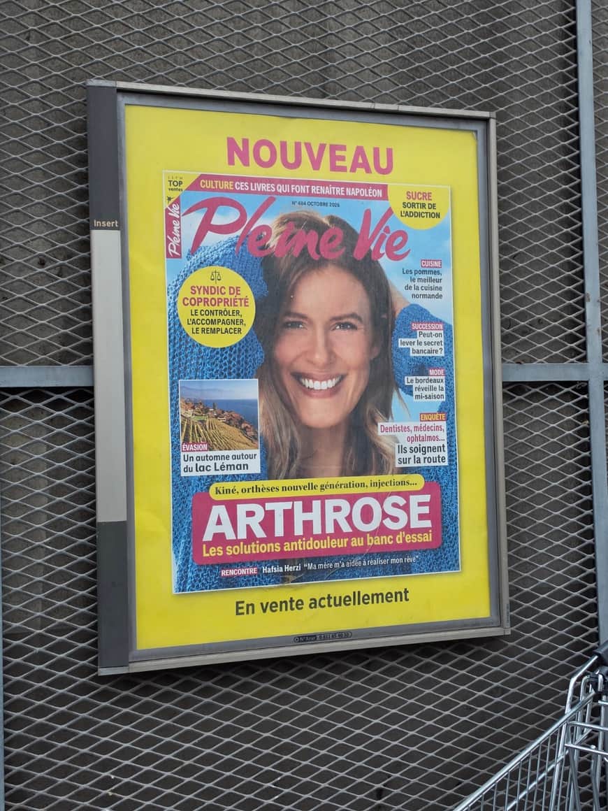 Publicité pour le magazine Pleine Vie consacrée à l’arthrose, photographiée derrière une grille métallique