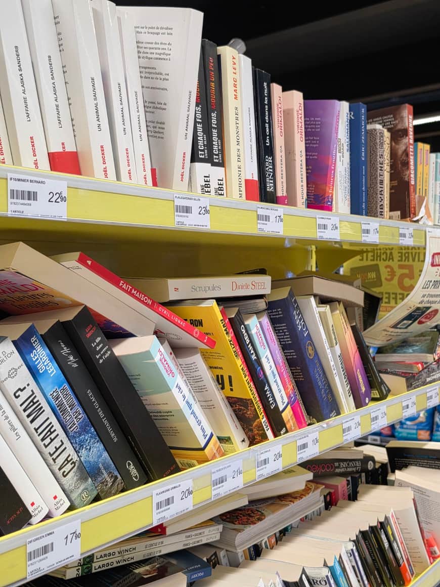 Rayonnages de livres irrégulièrement empilés avec étiquettes jaunes