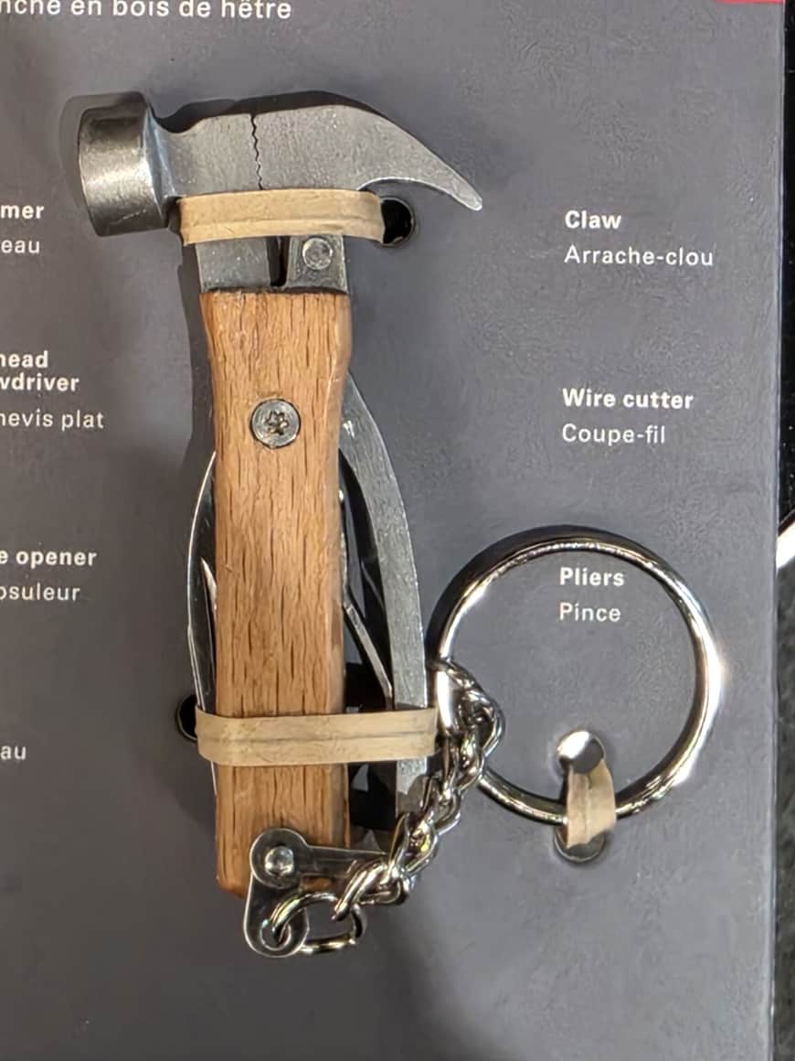 Outil multifonction à manche de bois présenté déplié avec pince, marteau et tournevis